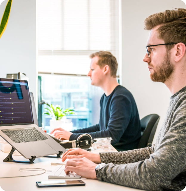 men working on laptops